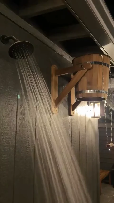 The bucket shower and the rain head under the lantern