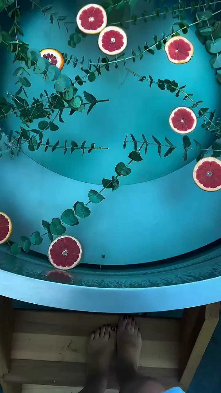 Hot tub from above, grapefruit slices and eucalyptus on the water